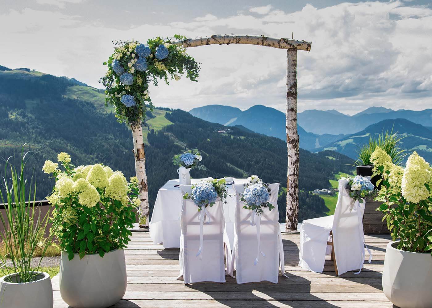 Eine Terrasse, geschmückt für eine Hochzeit, mit Blick auf Tiroler Berge